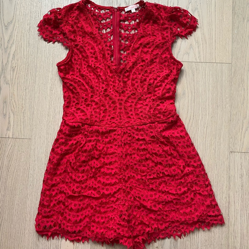 Red lace romper with v-neck and open lace back